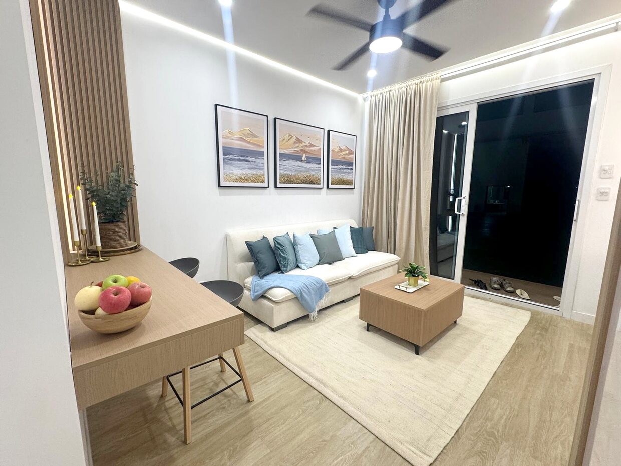 Living room with cream sofa, timber desk, sliding glass door and LED ceiling light